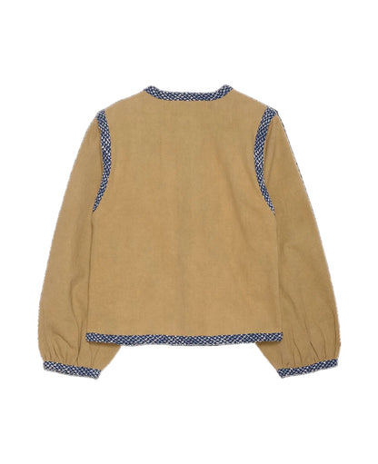 Beige jacket with blue patterned trim on a black background