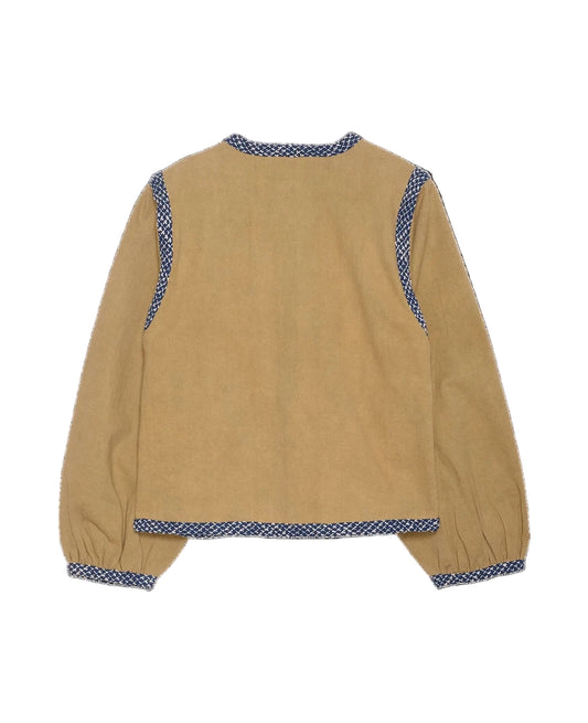 Beige jacket with blue patterned trim on a black background