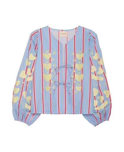 Light blue blouse with yellow heart patterns and red stripes on a black background