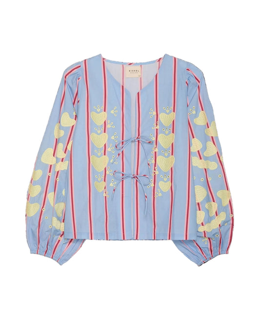 Light blue blouse with yellow heart patterns and red stripes on a black background