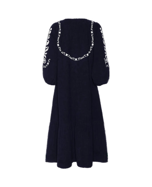 Navy blue dress with white pattern on sleeves against a black background