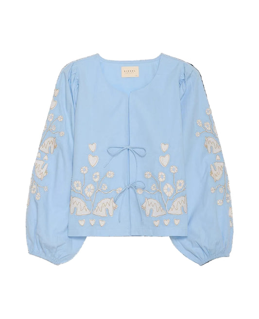 Light blue blouse with floral and elephant embroidery on a black background